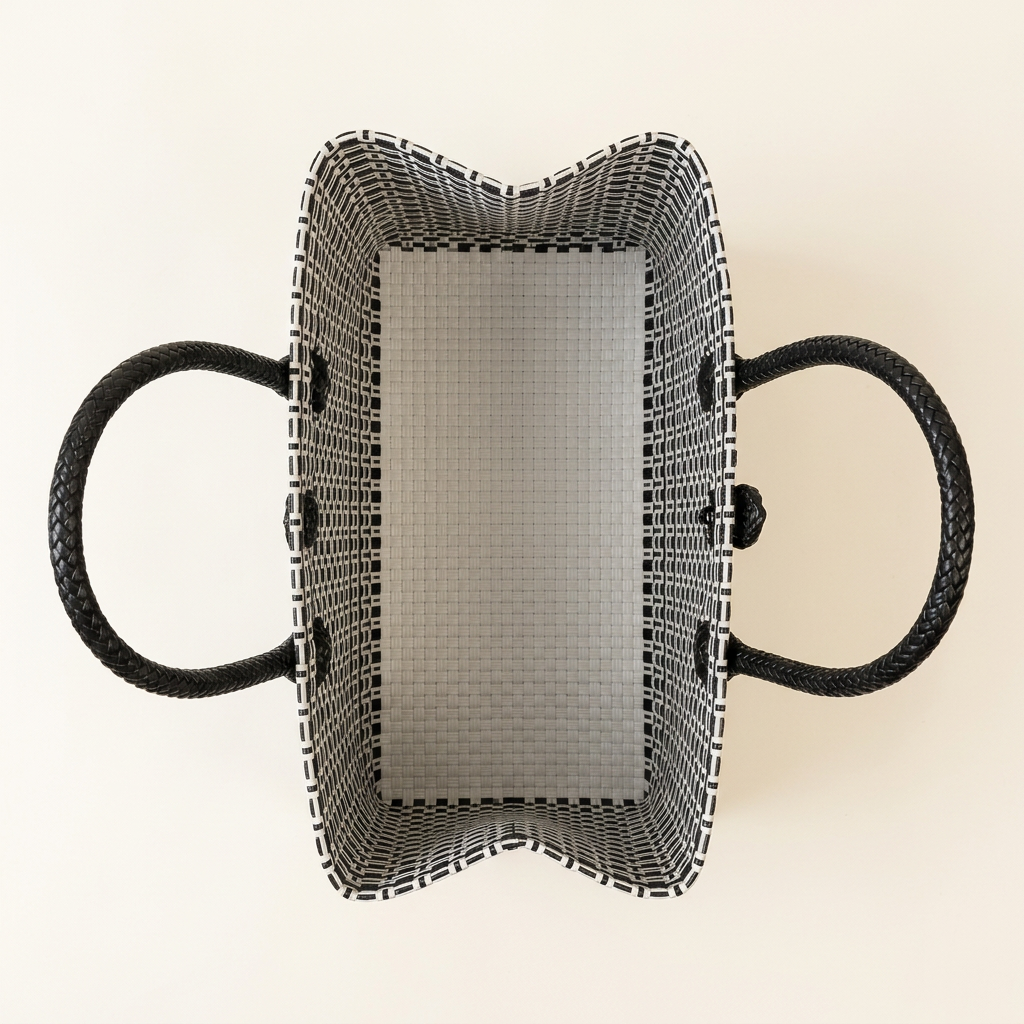 Aerial top-down view of black and white geometric woven tote