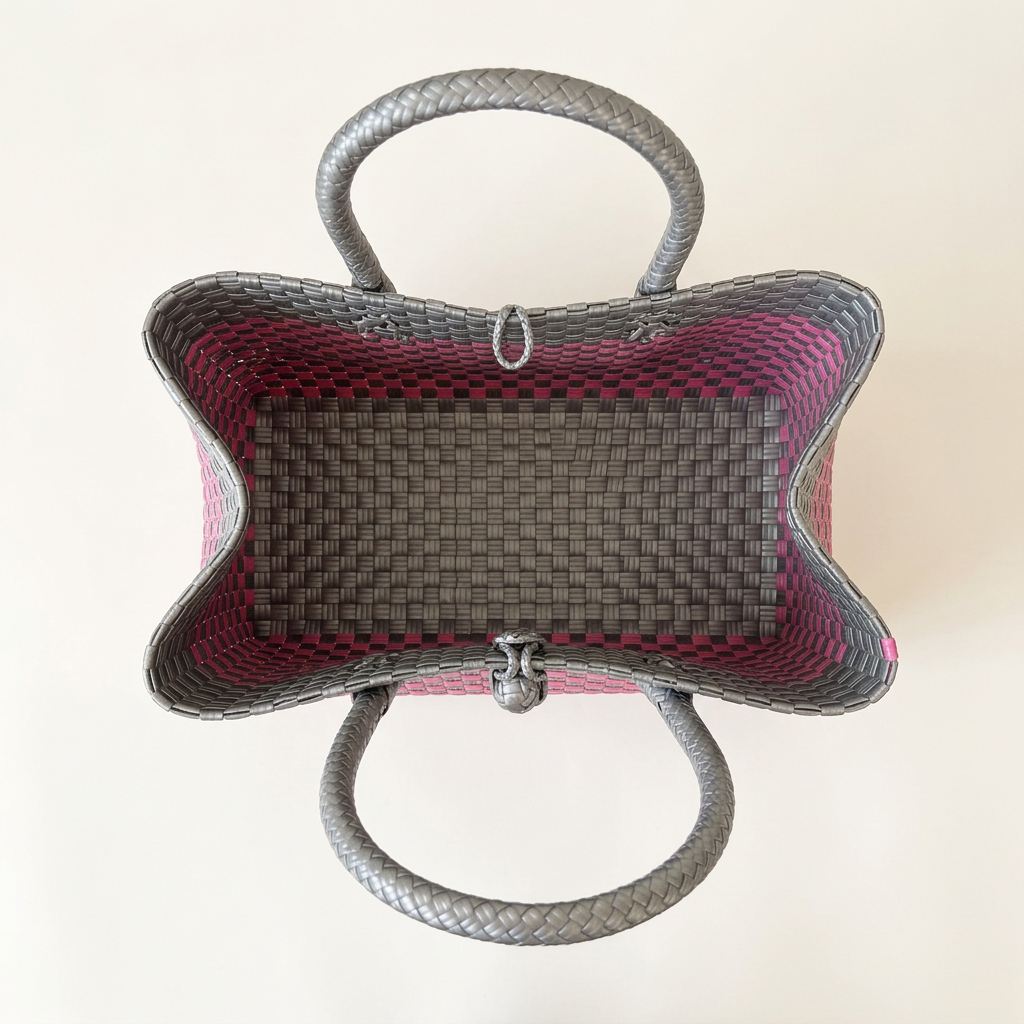 Aerial top-down view of pink and silver-gray woven tote