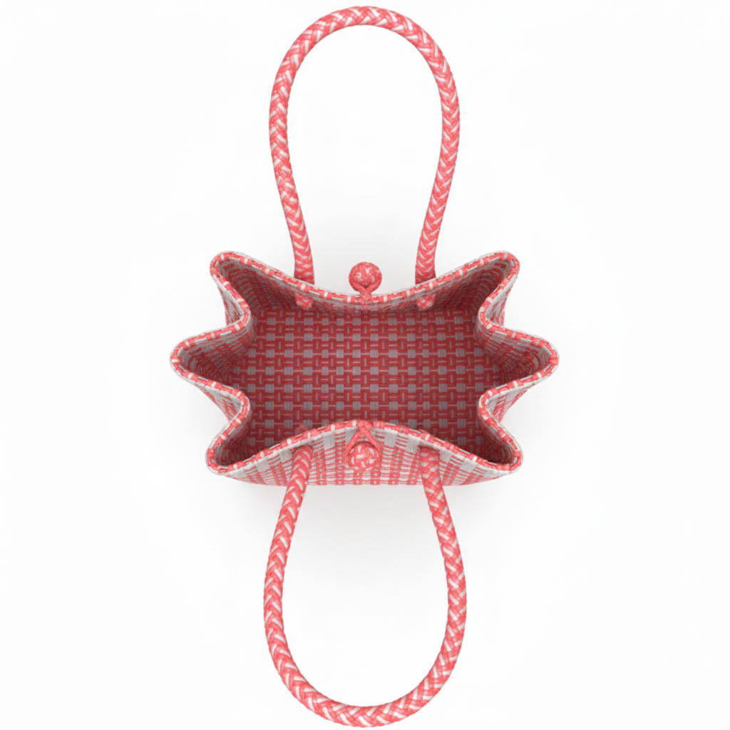 Aerial top-down view of the coral pink and white handwoven bag