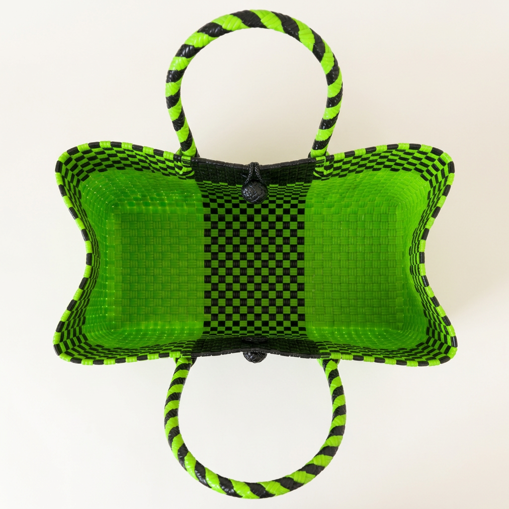 Aerial top-down view of lime green and black woven bayong tote
