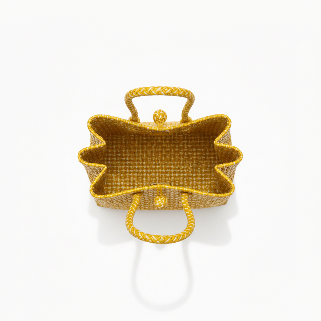 Aerial top-down view of the golden yellow handwoven bag