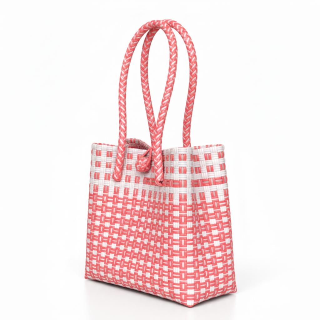30-degree angle view of the coral pink and white handwoven bag