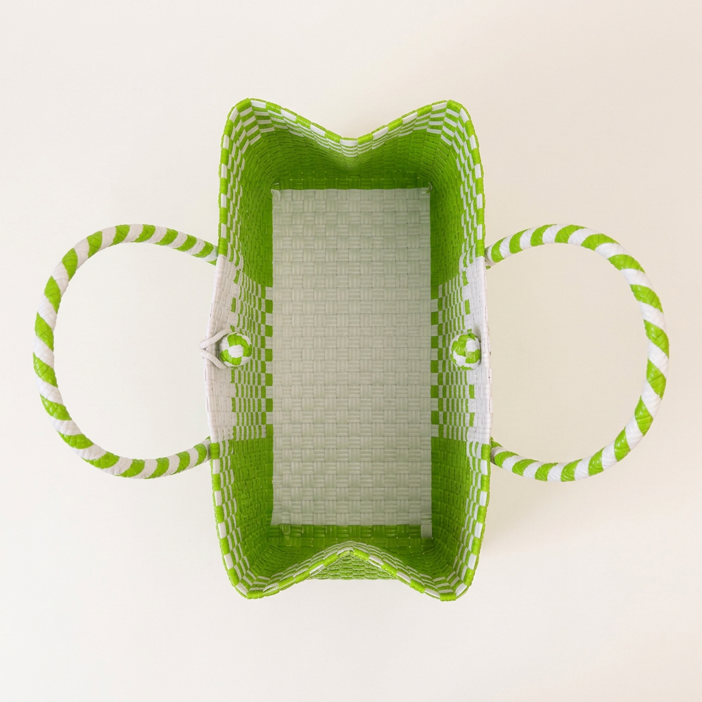 Aerial top-down view of lime green and white woven tote