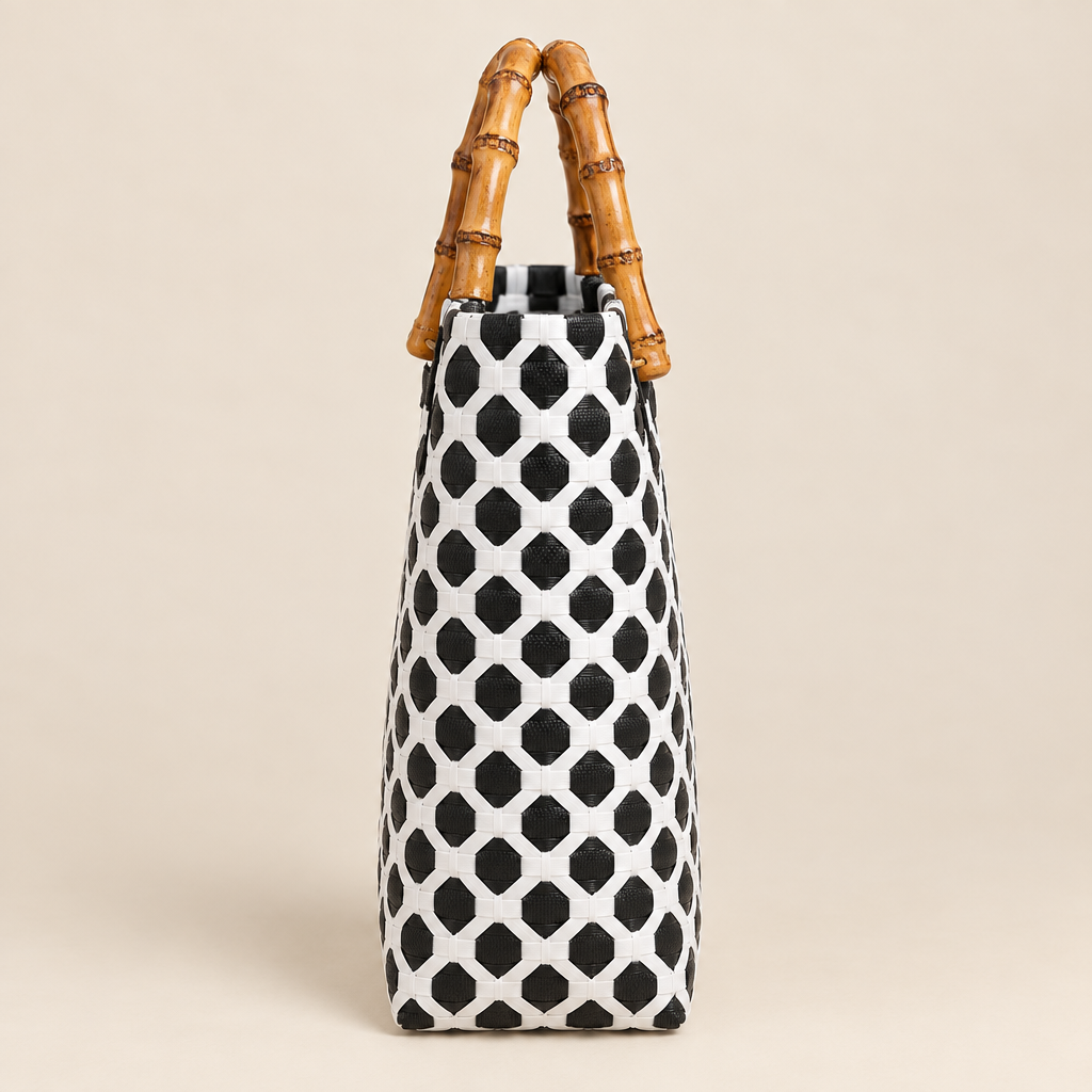 Side view of handwoven bag with bamboo handles